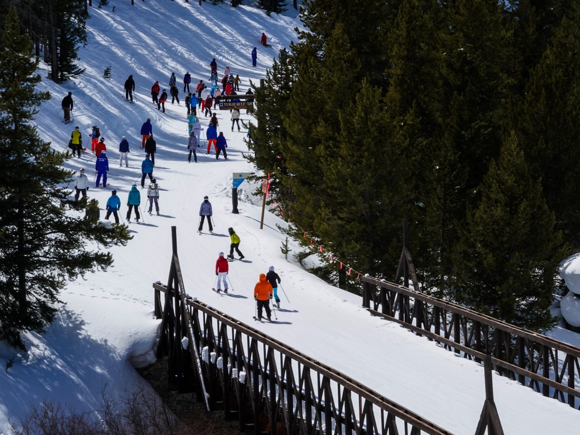 A group of skiers on a bridge enjoying the thrill of skiing with their Ski Passes
