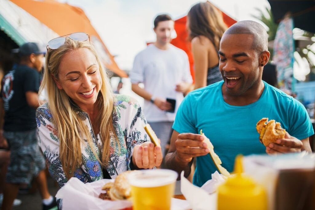 A man and woman enjoy eating at the Taste of Vail
